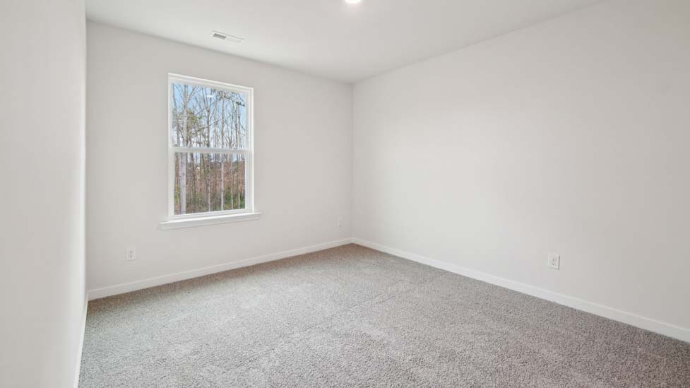 Carpeted bedroom with large window