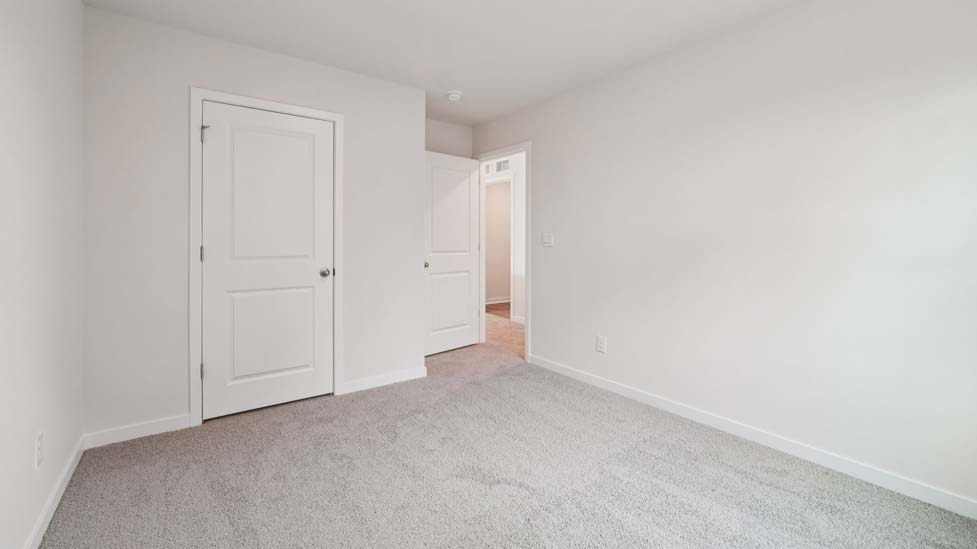 Carpeted bedroom with large window