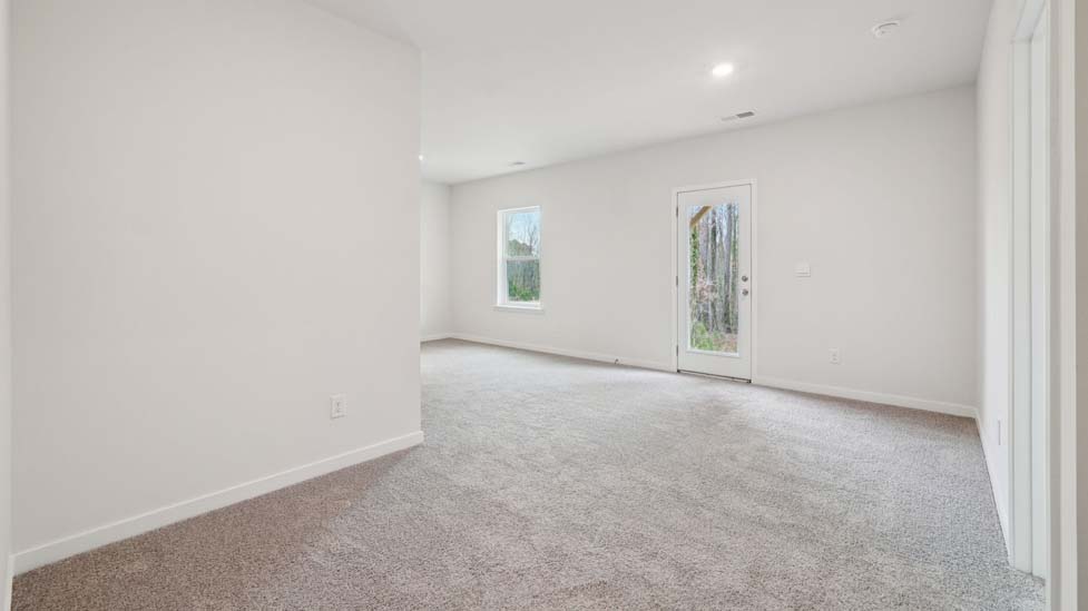 Carpeted bedroom with large window