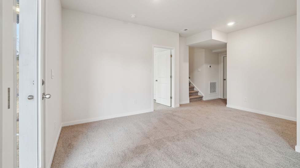 Carpeted bedroom with large window