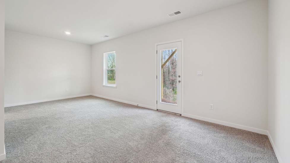Carpeted bedroom with large window