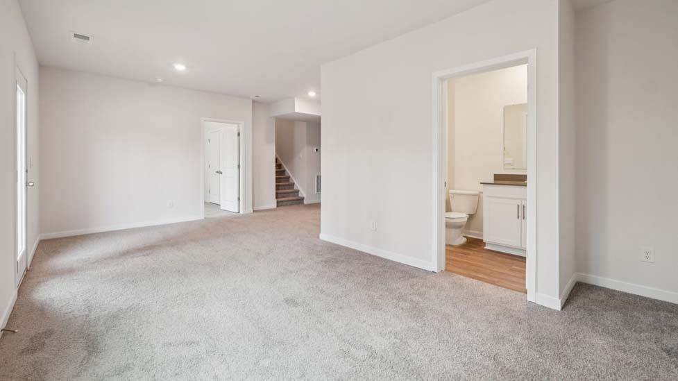 Carpeted bedroom with large window