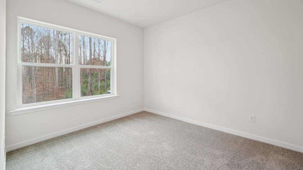 Carpeted bedroom with large window