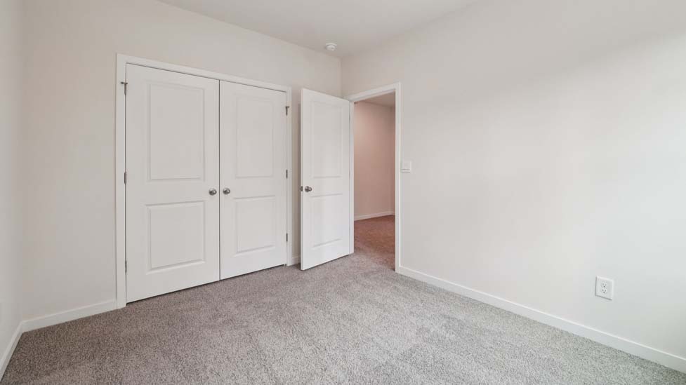 Carpeted bedroom with large window