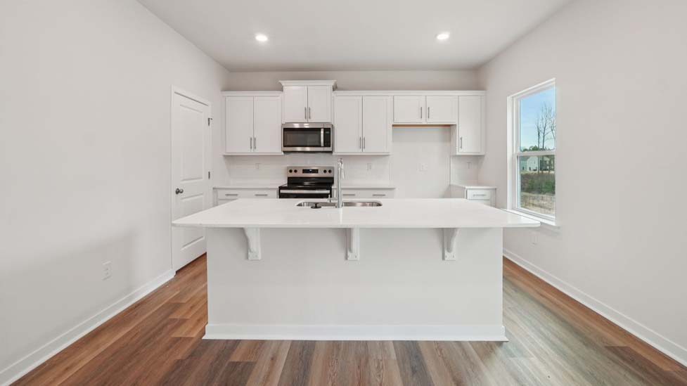 Kitchen and island with stainless steel appliances