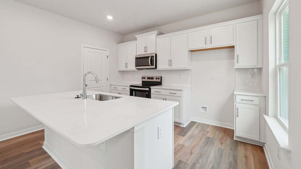 Kitchen and island with stainless steel appliances
