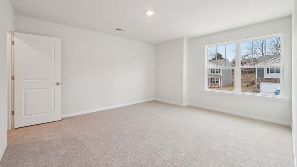 Carpeted bedroom with large window