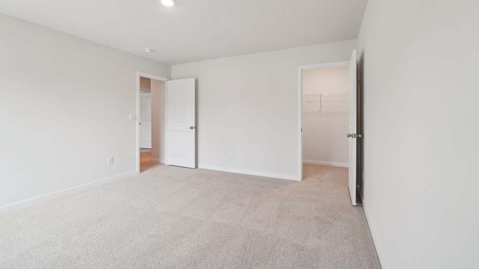 Carpeted bedroom with large window