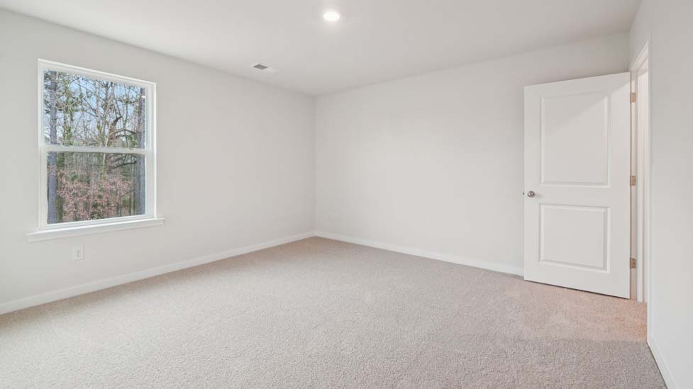Carpeted bedroom with large window