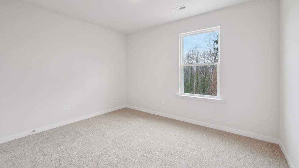 Carpeted bedroom with large window