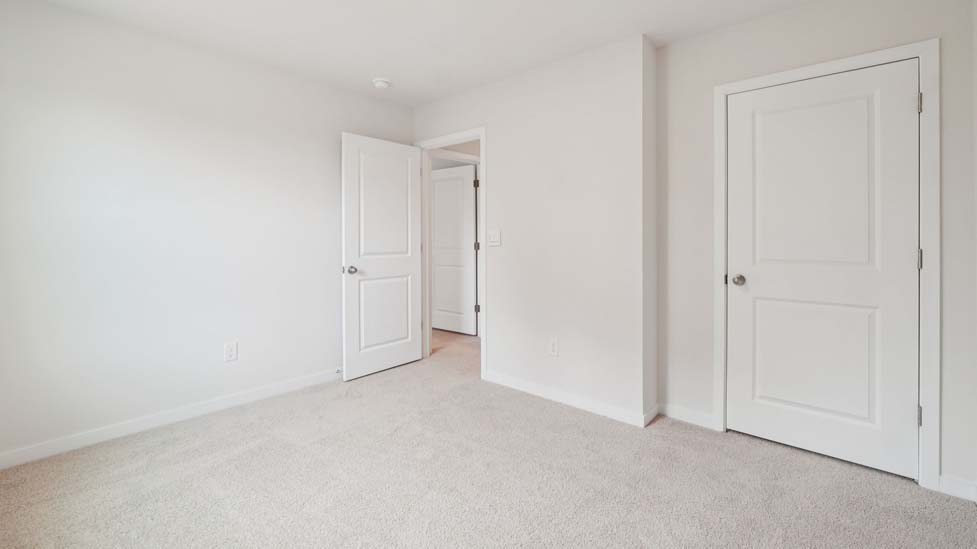 Carpeted bedroom with large window