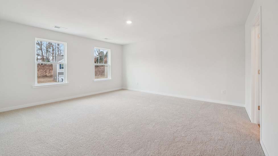 Carpeted bedroom with large window
