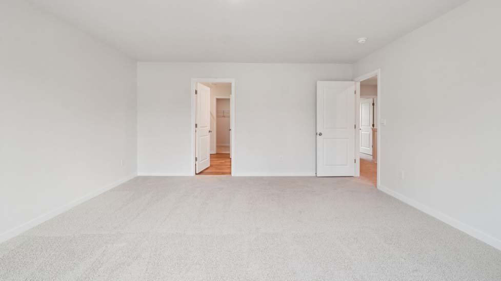 Carpeted bedroom with large window
