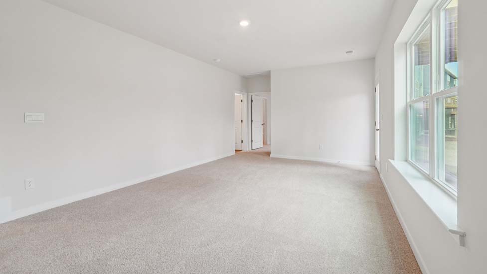 Carpeted bedroom with large window