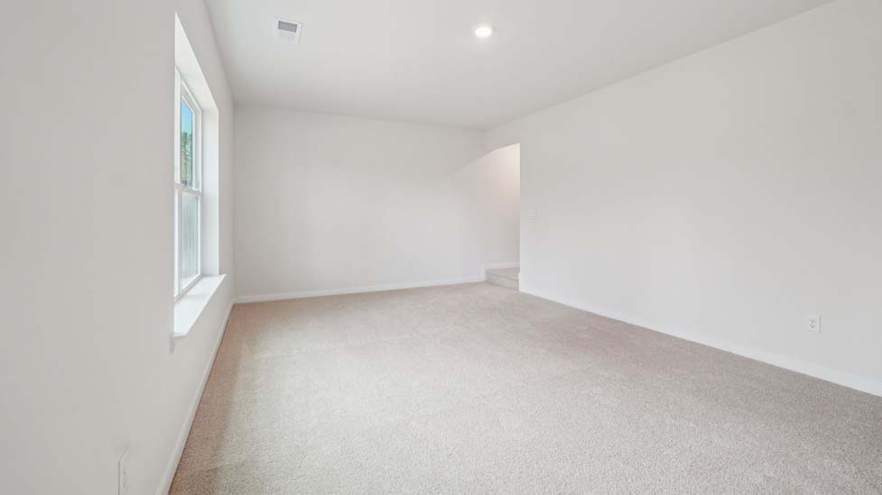Carpeted bedroom with large window