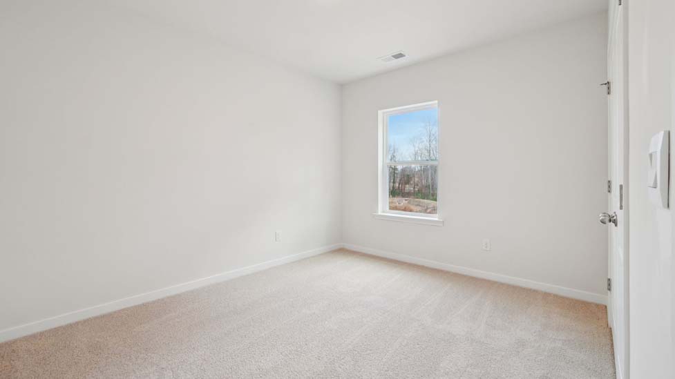 Carpeted bedroom with large window