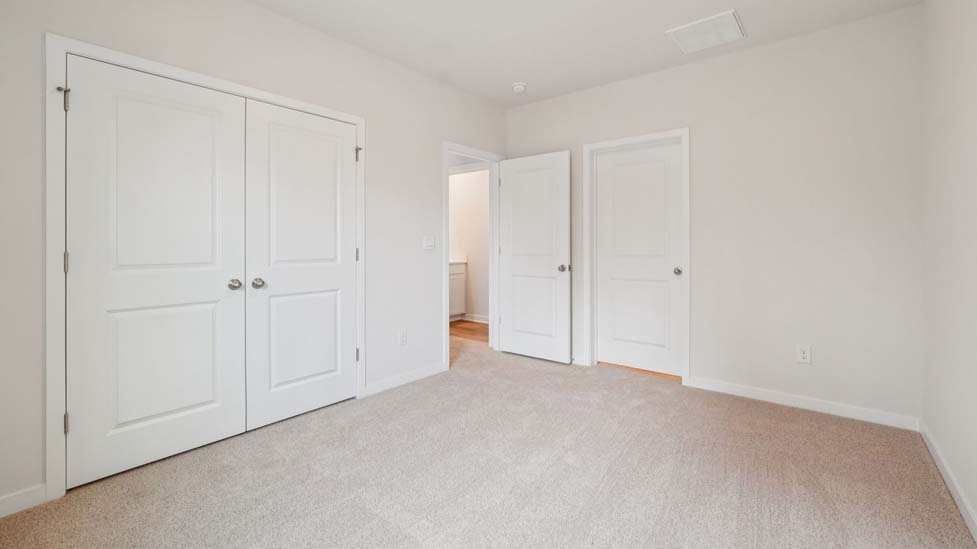 Carpeted bedroom with large window