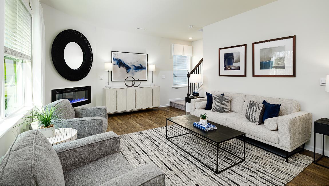 Open family room with fire place, vinyl floors, and large window