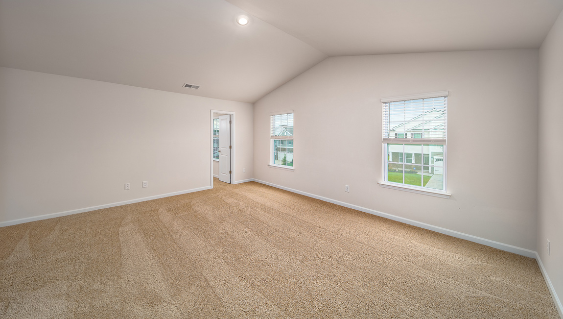 Primary bedroom, carpeted, two large windows