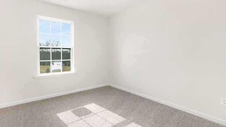 Carpeted bedroom with window