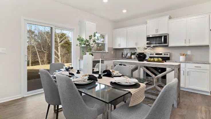 Dining area and living room beside kitchen
