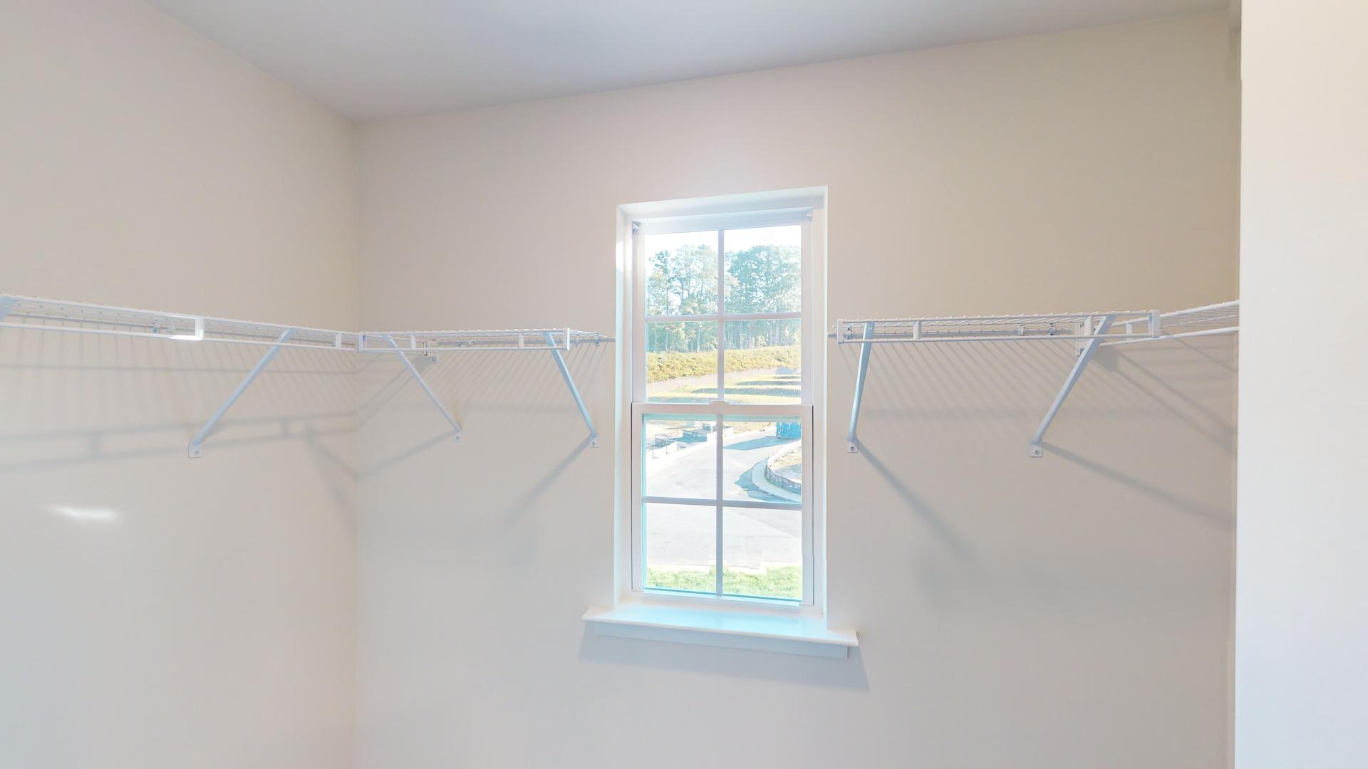 Primary bedroom walk in closet