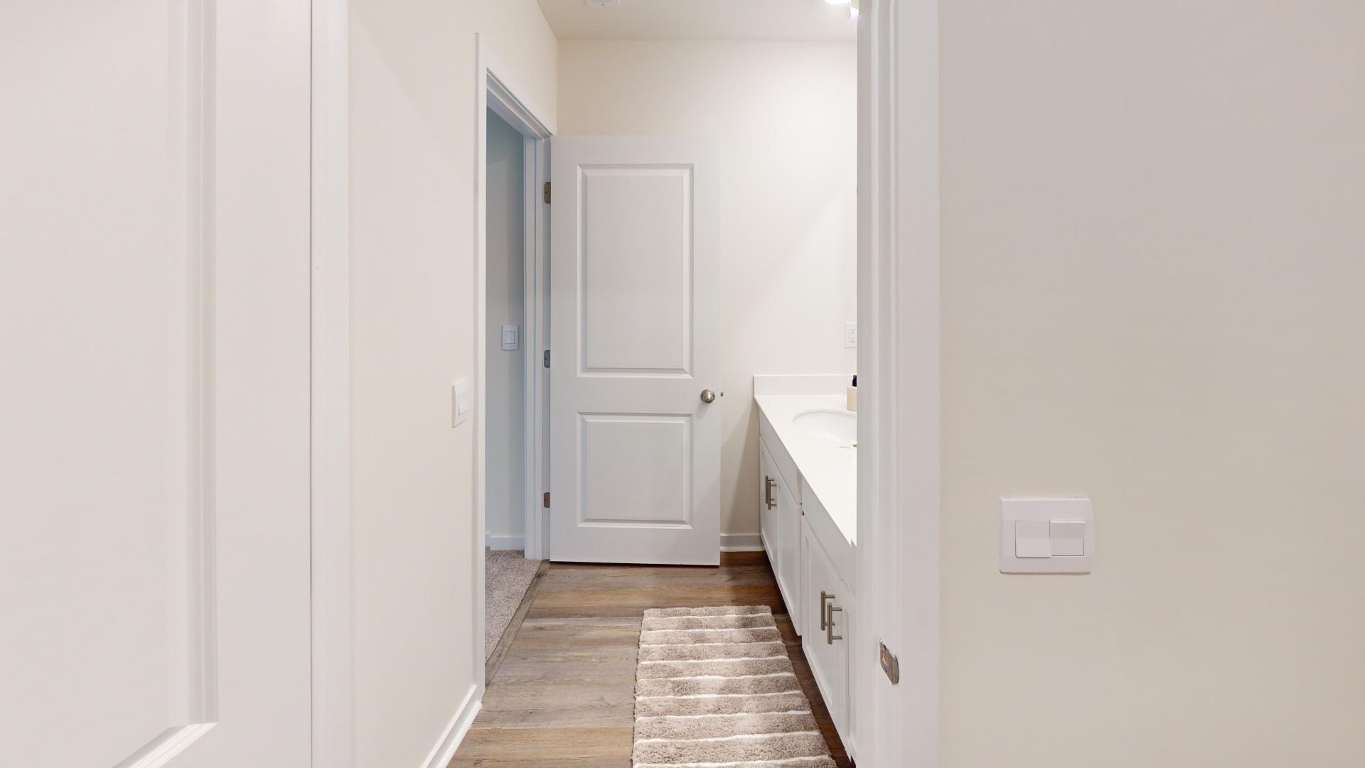 Primary bathroom with double sink vanity, and large standing glass door shower