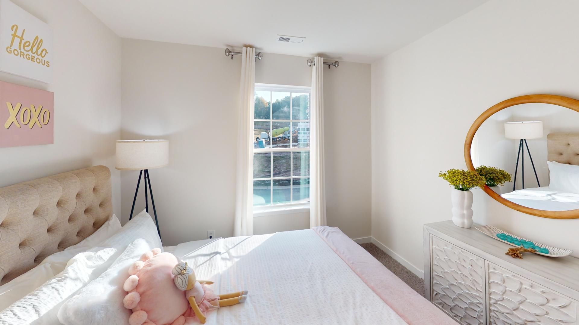 Carpeted bedroom with large window