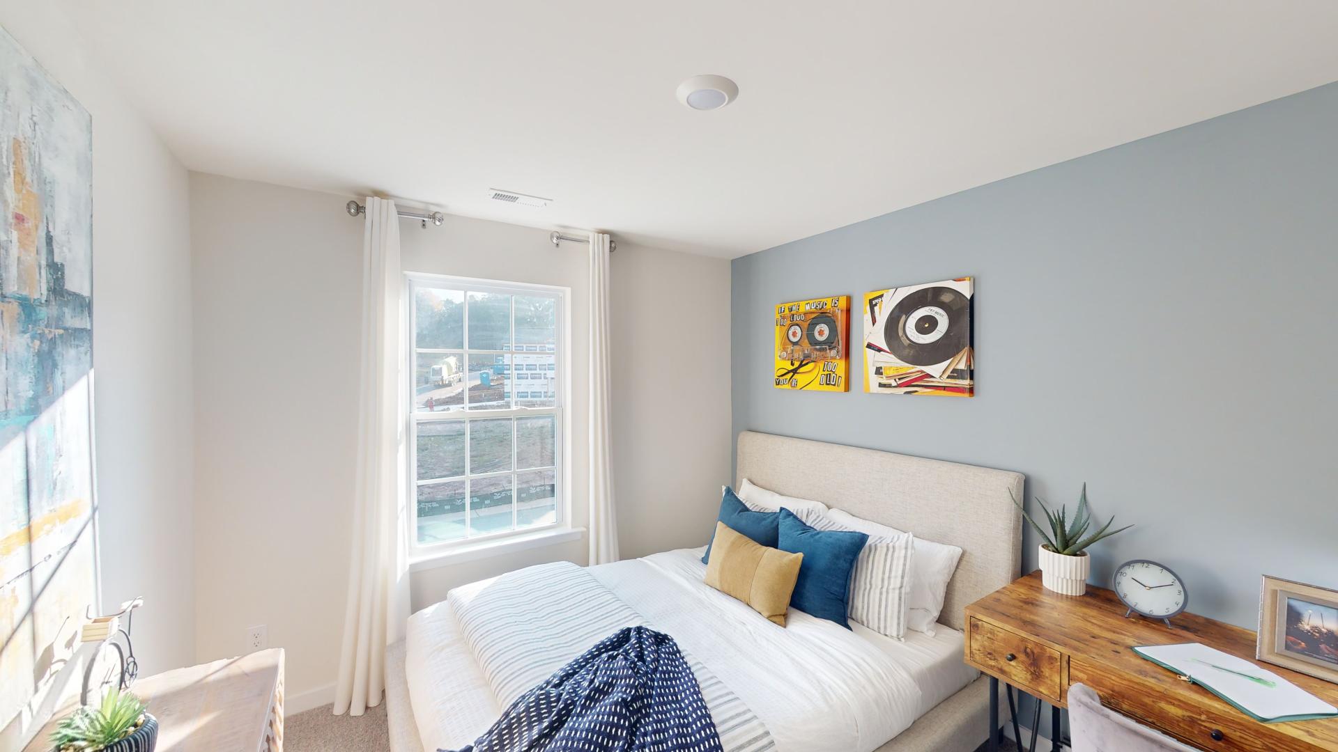 Carpeted bedroom with large window