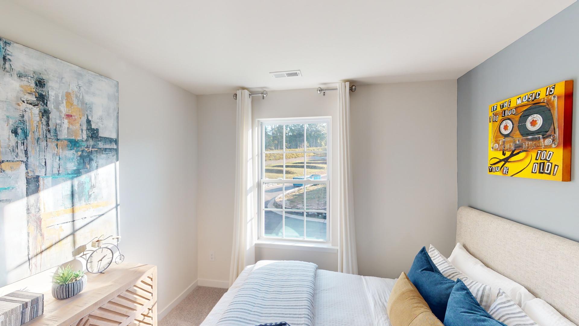 Carpeted bedroom with large window