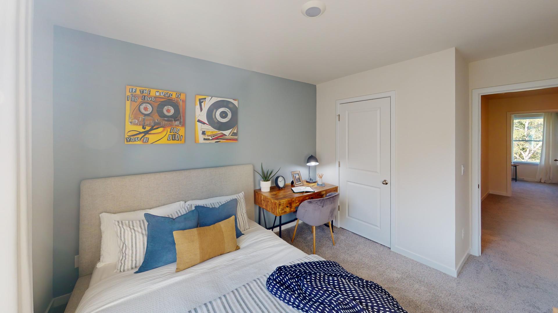 Carpeted bedroom with large window