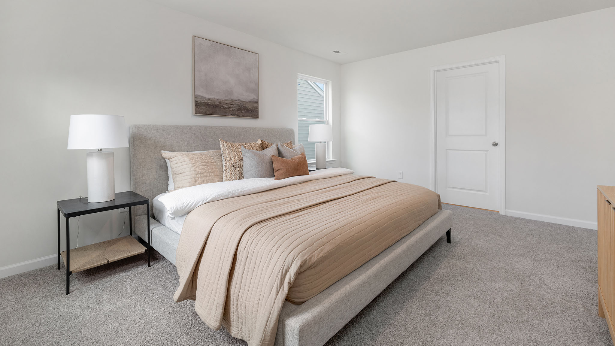 Primary bedroom, carpeted with large windows