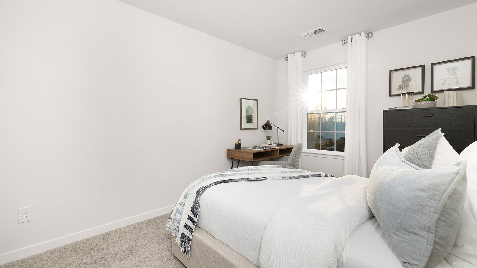 carpeted bedroom with large window