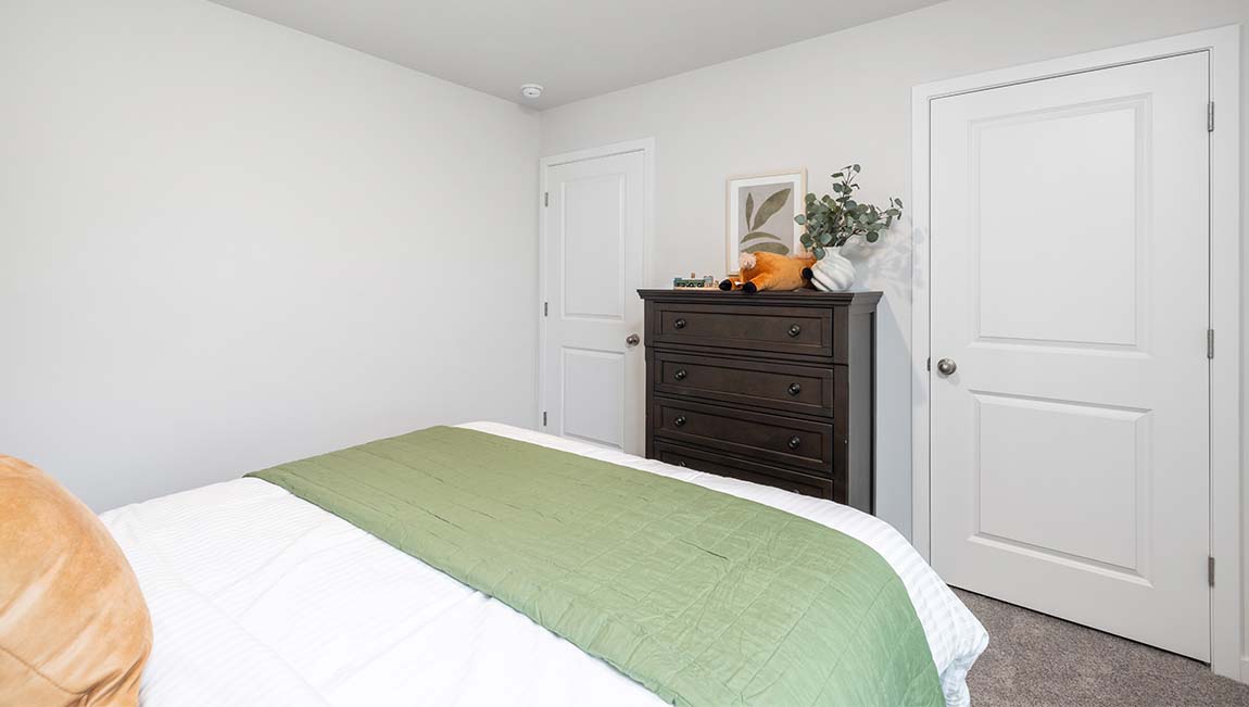 Carpeted bedroom with large window