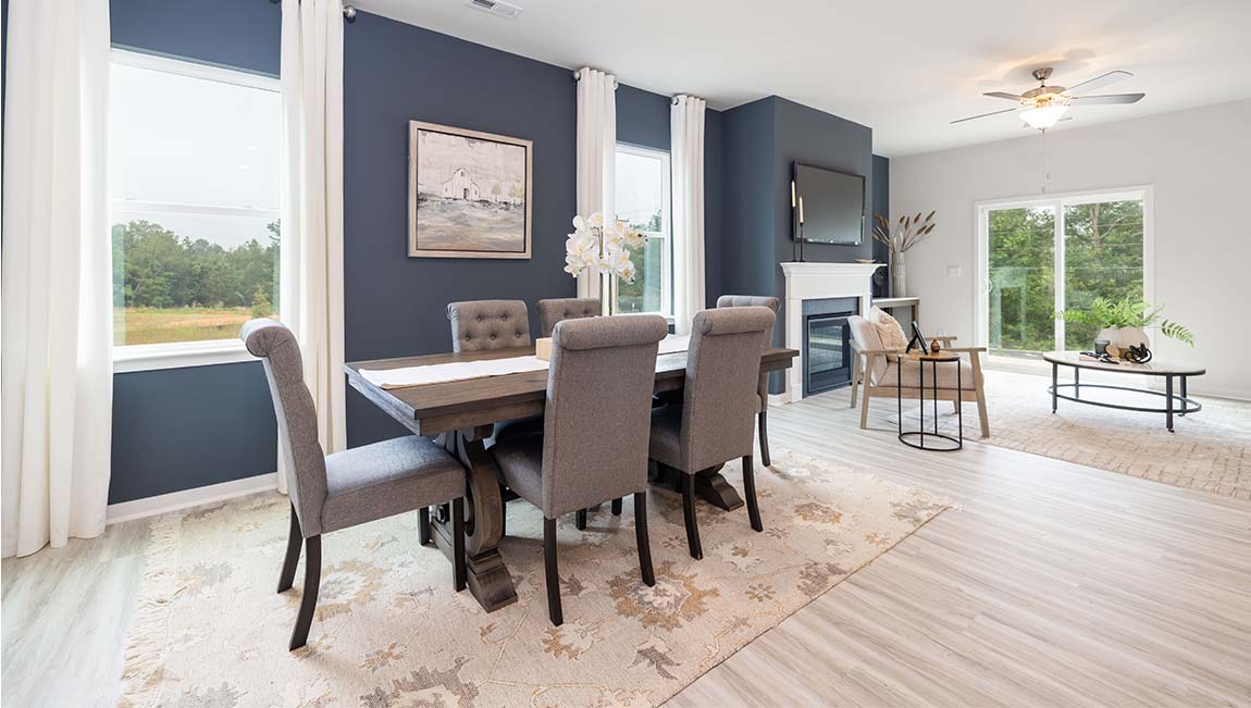 Dining area beside kitchen with large windows