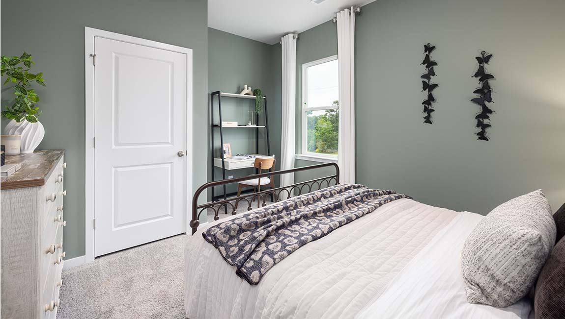 Carpeted bedroom with large window