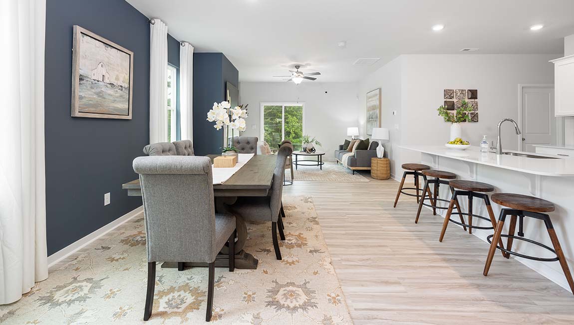 Dining area beside kitchen with large windows
