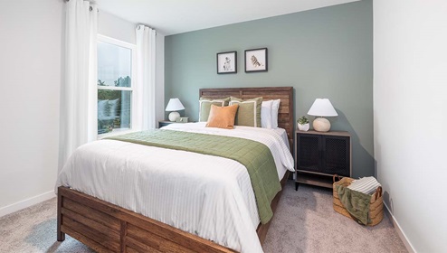 Carpeted bedroom with large window