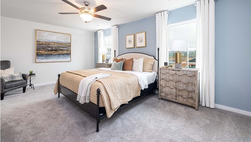 Carpeted bedroom with large window