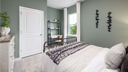 Carpeted bedroom with large window