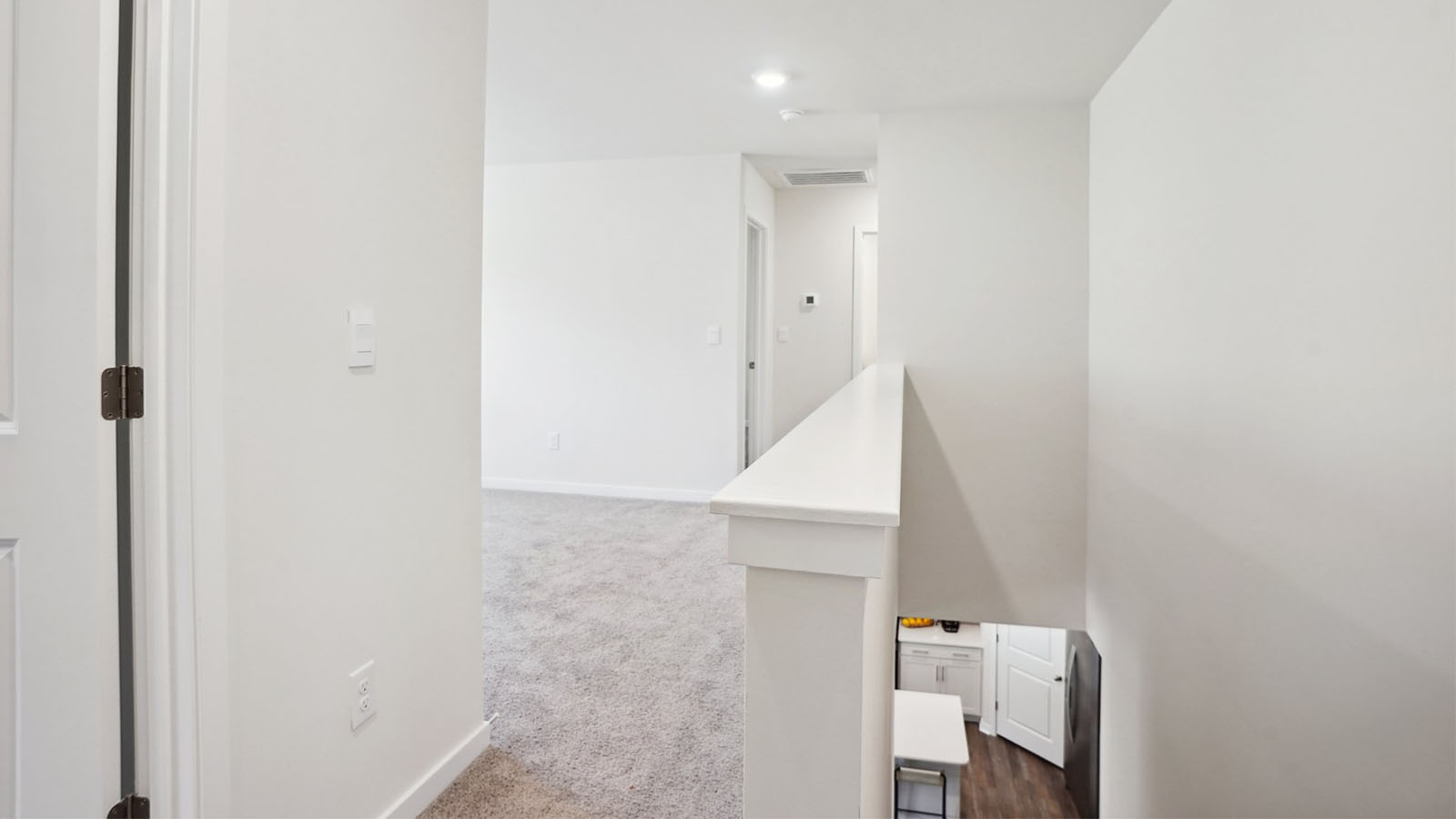 Model carpeted bedroom with small window