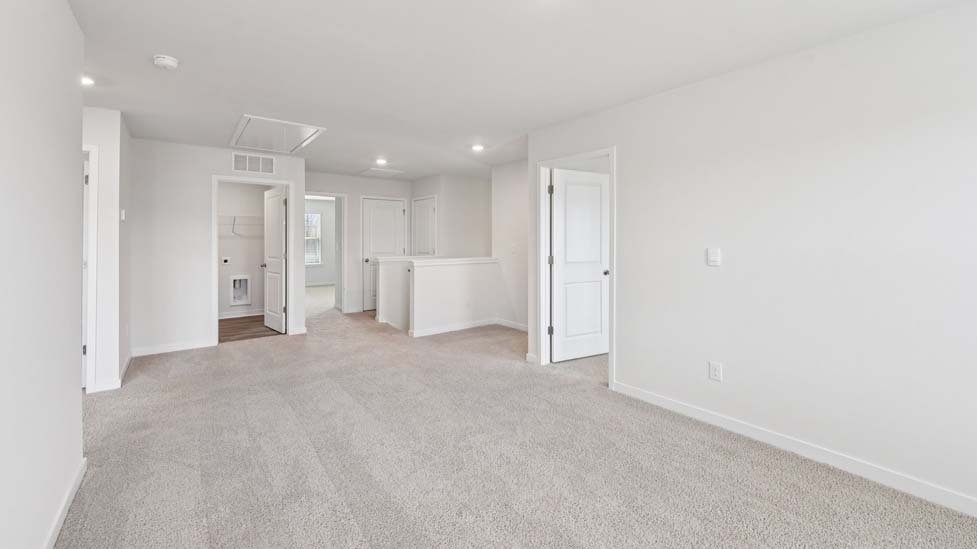 Carpeted bedroom with windows
