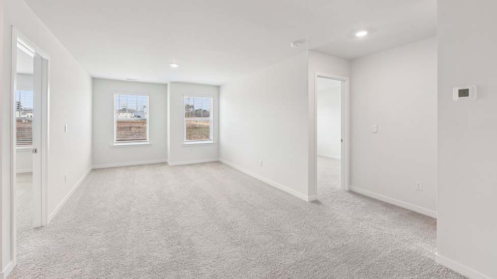 Carpeted bedroom with windows