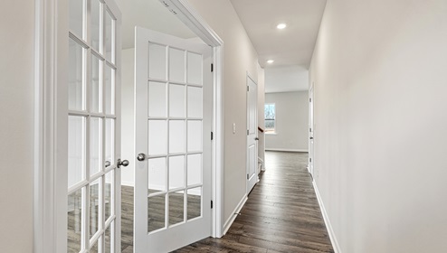 Welcoming foyer with wood floors, view of interior and french doors to flex room