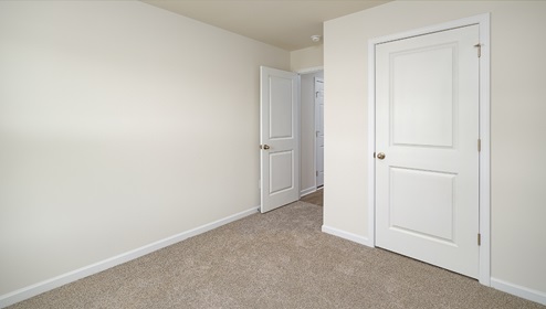 Carpeted bedroom, view of entrance door
