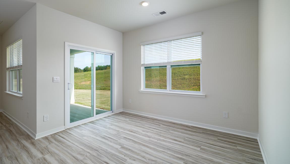 Dining room with wood floors, large window and sliding glass back door