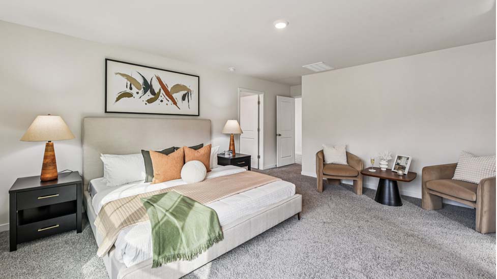 Primary carpeted bedroom with windows