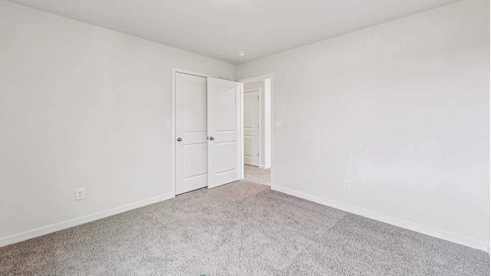 Carpeted bedroom with windows