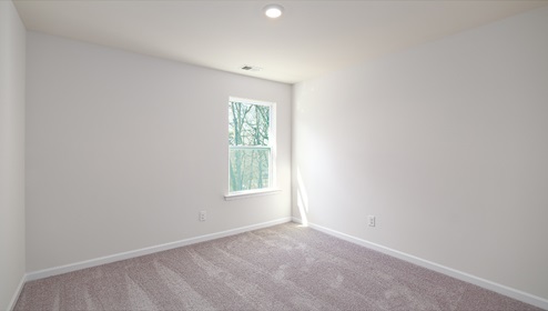 Carpeted bedroom  with small window