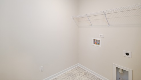 Laundry room with built in racks for hanging above machine space